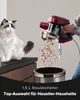 A person is emptying a handheld vacuum cleaner into a trash can, with a cat sitting nearby. Produktbild-Vorschau
