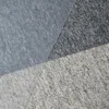 A close-up view of a textured material, likely a rug or carpet, with distinct color blocks. Náhled obrázku produktu