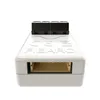 A white electronic device with a black connector on top and a tan connector on the front, set against a white background. Anteprima dell’immagine prodotto