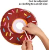 Hands adjusting a donut-shaped pet collar. Produktbild-Vorschau
