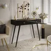 A modern vanity table setup with decorative elements and a chair. Produktbild-Vorschau