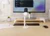 A desk setup with a monitor, keyboard, mouse, microphone, and a small plant. Náhled obrázku produktu