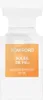 A white perfume bottle with an orange label. Voir les images du produit