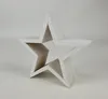 A white wooden star decoration against a white background. Produktbild-Vorschau