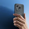 A hand holding a black smartphone with a textured case against a blue background. Produktbild-Vorschau
