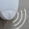 A close-up of a white motion sensor light mounted on a tiled wall, with graphic representations of motion waves emanating from it. Produktbild-Vorschau