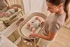 A mother is changing her baby's diaper on a changing table. Náhľad obrázku produktu