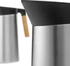 Close-up view of the top part of two stainless steel thermoses with black lids and one with a wooden handle. Voir les images du produit