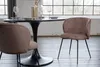 A dining table and chairs in a room with large windows. Produktbild-Vorschau