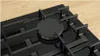 A close-up view of a black gas hob with metal pan supports. Anteprima dell’immagine prodotto