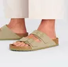 A close-up shot of a person's feet wearing Birkenstock Arizona sandals. Produktbild-Vorschau