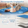 A woman is lying on a blue mattress, reading a book. The image also shows a layered diagram of the mattress. Náhled obrázku produktu