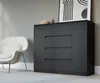 A modern living room scene with a black dresser and a white armchair. Produktbild-Vorschau