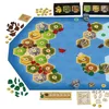 A board game with hexagonal tiles representing land and sea, along with various game pieces and tokens. Podgląd zdjęcia produktu