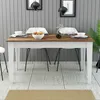 A dining table set up for a meal with place settings and a bowl of fruit. Anteprima dell’immagine prodotto