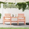 A wooden garden bench and table set on a patio with string lights overhead. Produktbild-Vorschau