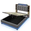 A modern upholstered bed frame with a tufted headboard and integrated storage, shown with the lifting mechanism for the storage compartment open. Podgląd zdjęcia produktu