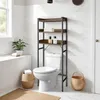 A bathroom shelf unit is shown above a toilet, with baskets and a plant nearby. Náhled obrázku produktu