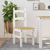 A white wooden chair with a light wood seat is shown in a room with a large potted plant and artwork on the wall. Produktbild-Vorschau