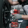 A person is using a cordless impact wrench to change a car tire. Podgląd zdjęcia produktu