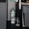 Under a sink, showing a water filter and cleaning supplies. Produktbild-Vorschau