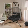 A living room scene with a hanging chair, bookshelf, and sofa. Produktbild-Vorschau