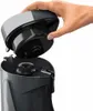 A hand is shown removing the lid from a gray and black appliance. Anteprima dell’immagine prodotto