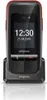 A black and red Emporia ONE flip phone is shown in its charging dock against a white background. Podgląd zdjęcia produktu
