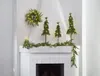 Christmas decorations on a fireplace mantel. Produktbild-Vorschau
