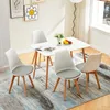 A dining set with four chairs and a table in a bright, modern room. Voir les images du produit