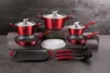 A set of red cookware with silver lids and black accents is displayed on a dark gray surface against a textured dark gray background. Anteprima dell’immagine prodotto