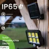 A solar-powered outdoor wall light with a motion sensor is mounted on a wooden post during a rain shower. The image highlights the product's features and specifications. Produktbild-Vorschau