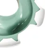 A close-up view of a green and white children's toilet seat. Voir les images du produit