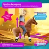 A young girl is riding a plush toy horse indoors, with colorful graphics and text overlays. Produktbild-Vorschau