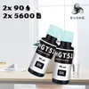 Two black ink bottles with light blue caps are displayed on a desk with a blurred background of an office or home environment. Produktbild-Vorschau