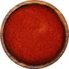 A top-down view of ground chili powder in a wooden bowl. Produktbild-Vorschau