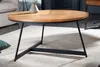 A round coffee table with a wooden top and black metal legs is placed on a rug in a living room setting. Produktbild-Vorschau