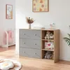 A nursery room with a dresser and shelves filled with toys and baby items. Produktbild-Vorschau