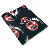 A folded fleece blanket with a repeating pattern of the 1. FC Köln logo and a goat. Anteprima dell’immagine prodotto