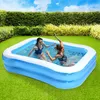 Two women are playing in an inflatable swimming pool in a backyard. Podgląd zdjęcia produktu