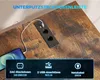 A close-up of a power strip with USB ports integrated into a wooden surface, with a phone charging. Anteprima dell’immagine prodotto