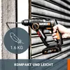 A hand holding a cordless hammer drill, with a drill bit inserted into a wall. Produktbild-Vorschau