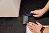 Hands are shown cutting a carpet tile with a utility knife. Produktbild-Vorschau