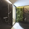 A modern bathroom with a shower, bathtub, and a living wall. Produktbild-Vorschau