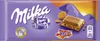 A Milka & Daim chocolate bar packaging with a piece of chocolate and caramel chunks shown. Produktbild-Vorschau