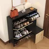 A black shoe cabinet with multiple shelves holding various shoes and a bench attached. Náhled obrázku produktu