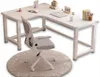 A white L-shaped computer desk with a white office chair on a round rug. Produktbild-Vorschau