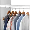Several shirts are hanging on a white clothes rack. Produktbild-Vorschau