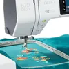 A close-up view of a sewing machine with an embroidery hoop and fabric. Produktbild-Vorschau