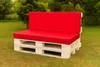 A white pallet sofa with red cushions sits on a grassy lawn, with trees in the background. Produktbild-Vorschau
